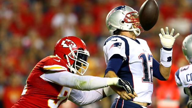 KANSAS CITY, MO - SEPTEMBER 29: Tamba Hali #91 of the Kansas City Chiefs knocks the ball loose from Tom Brady #12 of the New England Patriots for a fumble during the third quarter at Arrowhead Stadium on September 29, 2014 in Kansas City, Missouri. (Photo by Dilip Vishwanat/Getty Images)